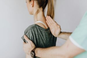 a person holding a woman's shoulder